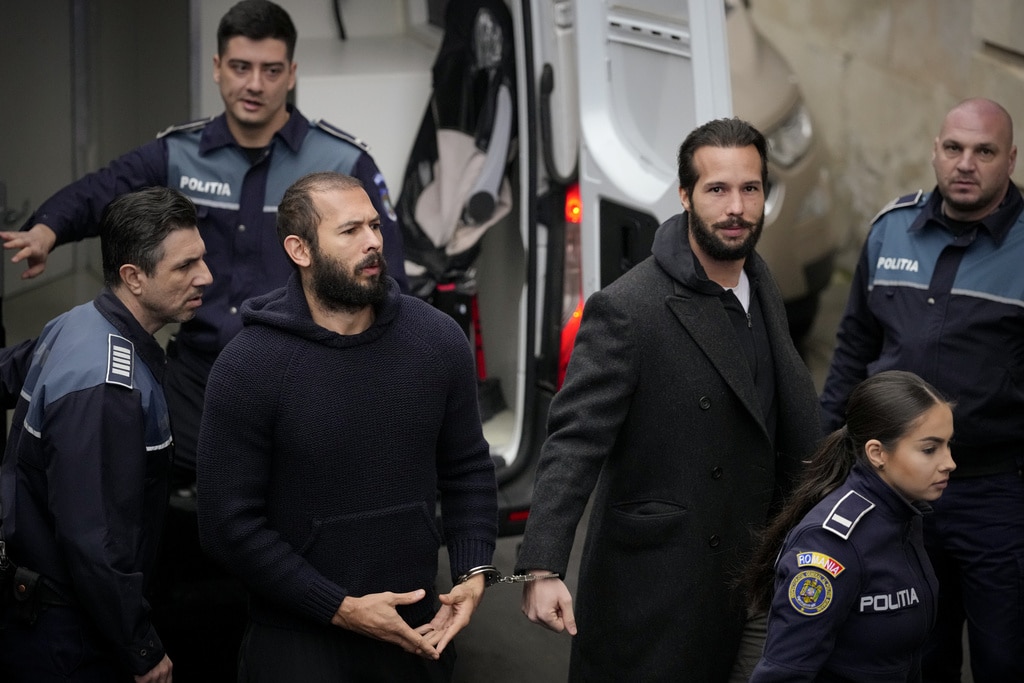 Influencer Tate brothers, who face human trafficking charges, arrive in the US