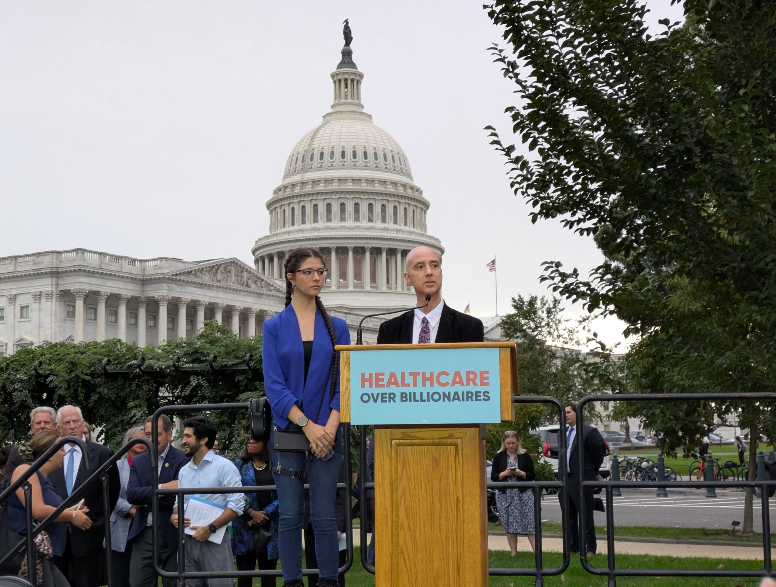 Tony Gonzales, his daughter Amber at left, talks about his increasing insurance premium on his plan through Pennsylvania's Pennie health insurance exchange at a rally on Capitol Hill on Tuesday, Sept. 30, 2025. Gonzales, of Pennsylvania, was diagnosed two years ago with Stage 4 thymic carcinoma, a rare cancer, and said he relies on health coverage to afford treatment. (Photo by Ashley Murray/States Newsroom)