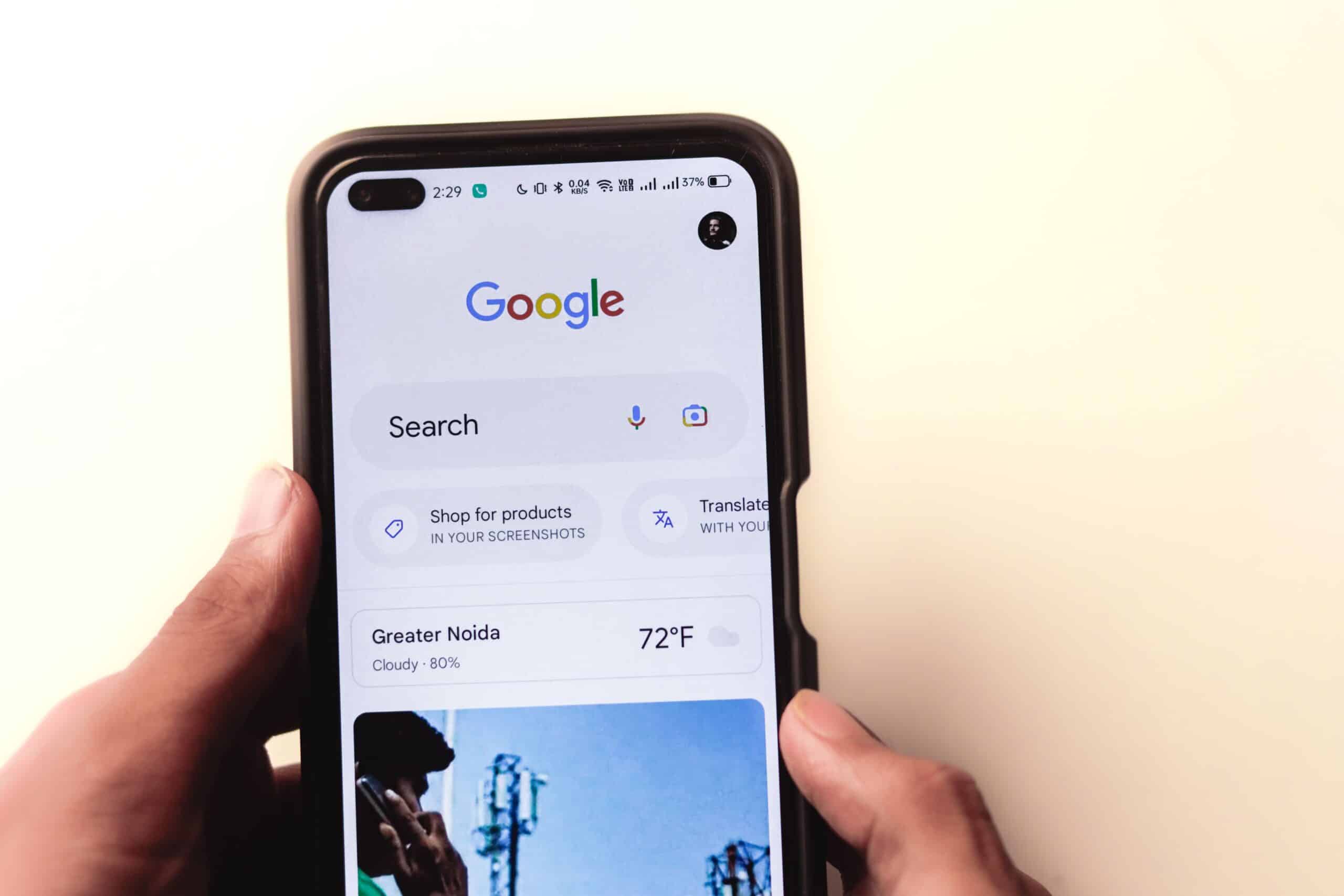 Hand holding a smartphone showing the Google search page, highlighting why mobile SEO matters for visibility on phones.